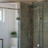 Frameless glass walk-in shower enclosure in a modern bathroom