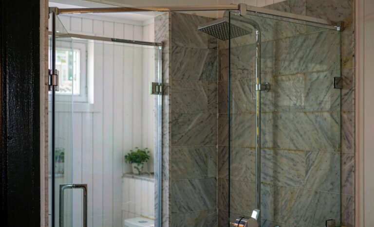 Frameless glass walk-in shower enclosure in a modern bathroom