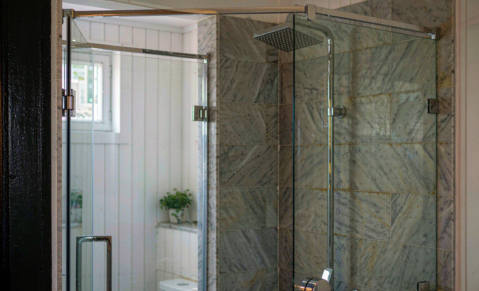 Frameless glass walk-in shower enclosure in a modern bathroom