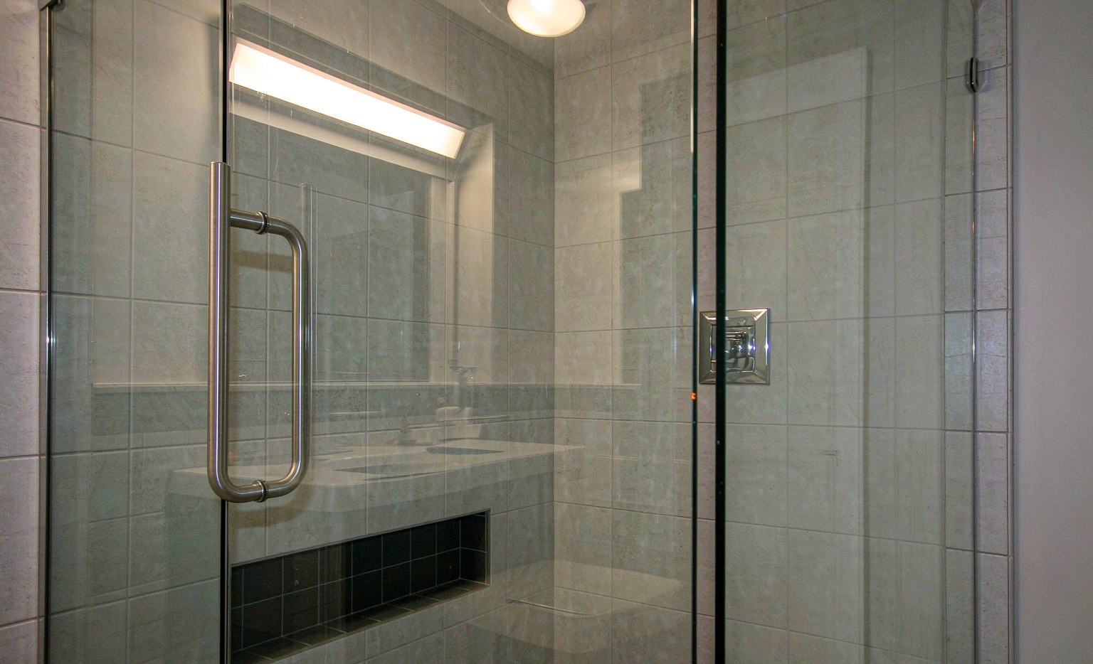 Frameless tempered glass shower panel with polished edges