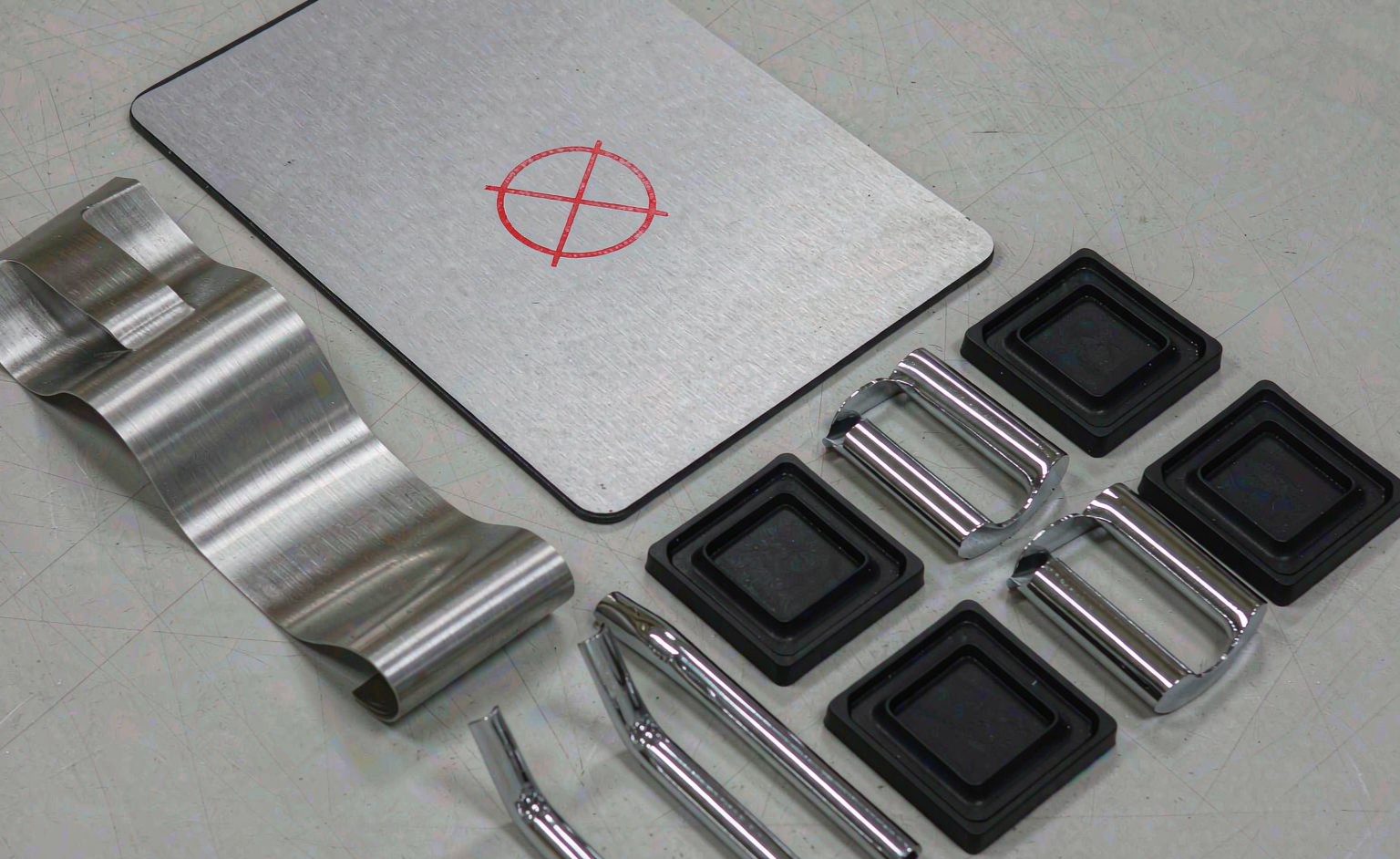 Shower hardware sample parts beside a stamped report folder on a laboratory table